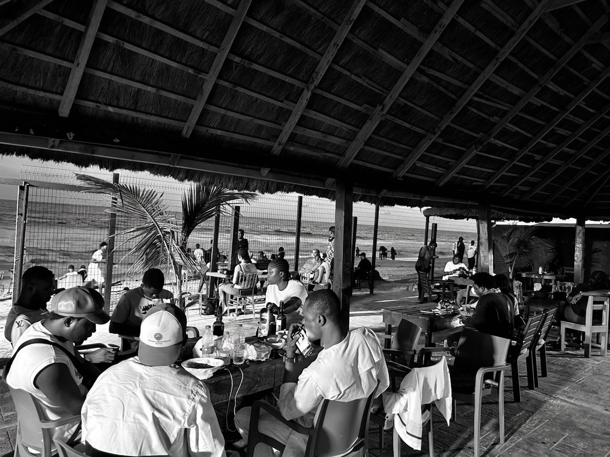 Guests eating at long tables in the beachfront bar